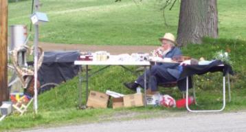 Amish grandfather at roadstand  contributing to the Amish family